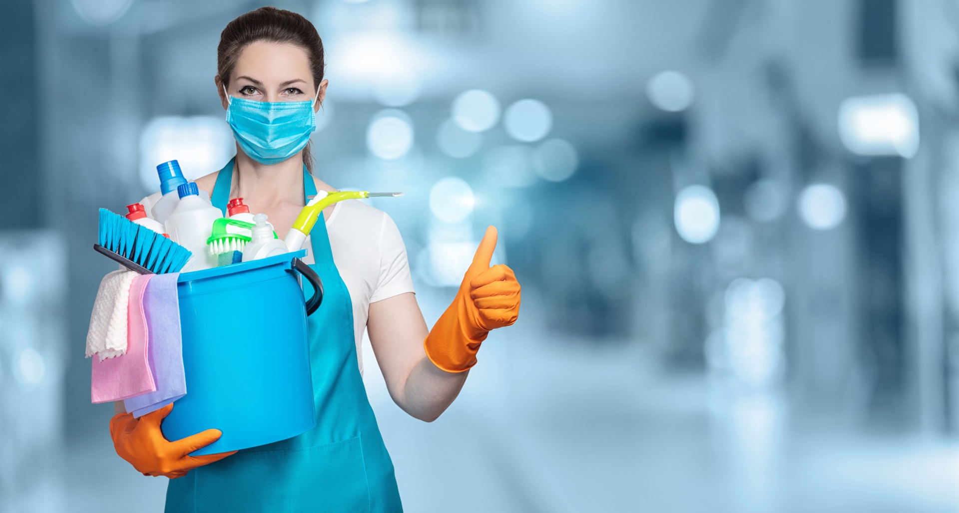 Woman in cleaning uniform giving thumbs up